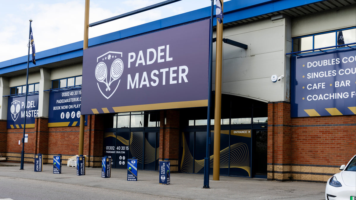 The exterior of the Padel Master facility in Doncaster, featuring a large purple and blue sign with a tennis racket logo